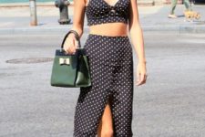 With polka dot wrap skirt, beige shoes and dark green bag