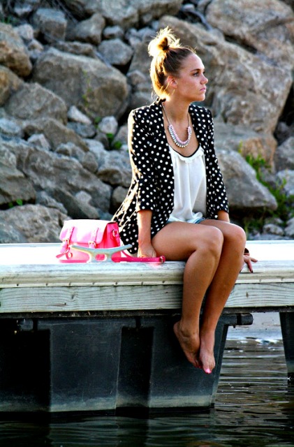 With shorts, white blouse and pink bag