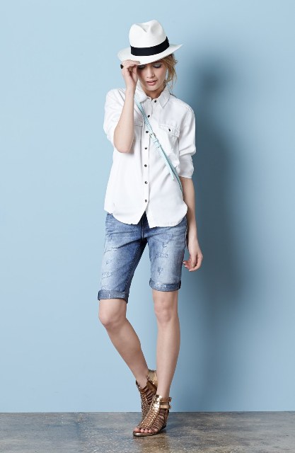With white button down shirt, hat, crossbody bag and sandals