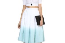 With white crop top, white sandals and black clutch