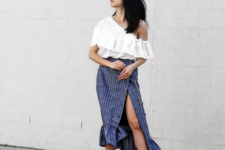 With white ruffle blouse, striped skirt and black shoes