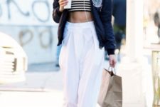 With white trousers and navy blue bomber jacket