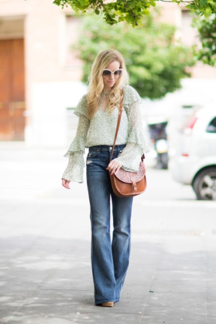 With wide leg jeans, brown leather bag and heels