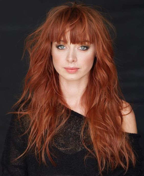 long cascading shag red hair with a long fringe for a messy and romantic look