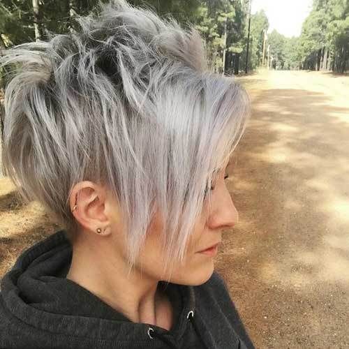 a longer pixie haircut with bangs with trendy grey balayage looks daring and cool