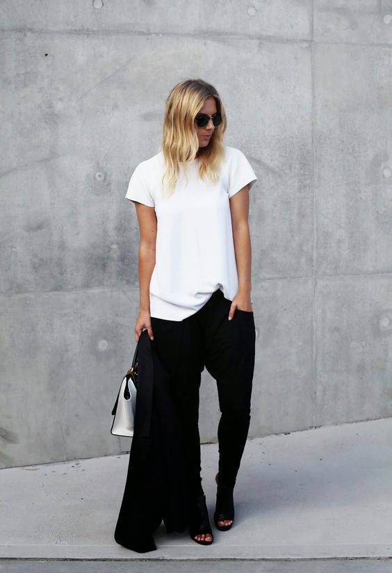 a white tee, black pants, black mules and a black jacket for a minimalist chic office look