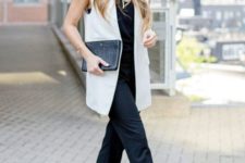05 a black jumpsuit, a creamy long vest, a black clutch and floral strappy heels that spruce up the look