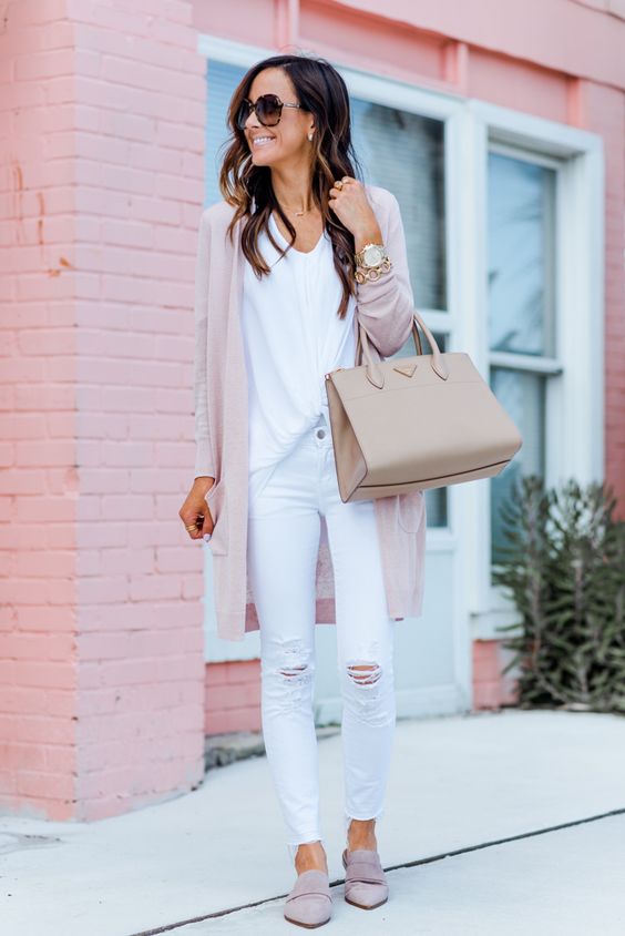 a white top, white ripped jeans, blush flats, a blush cardigan and a neutral bag