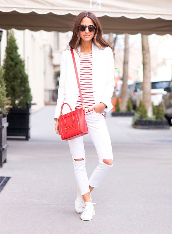 white ripped skinnies, white sneakers, a striped tee, a white blazer and a red bag