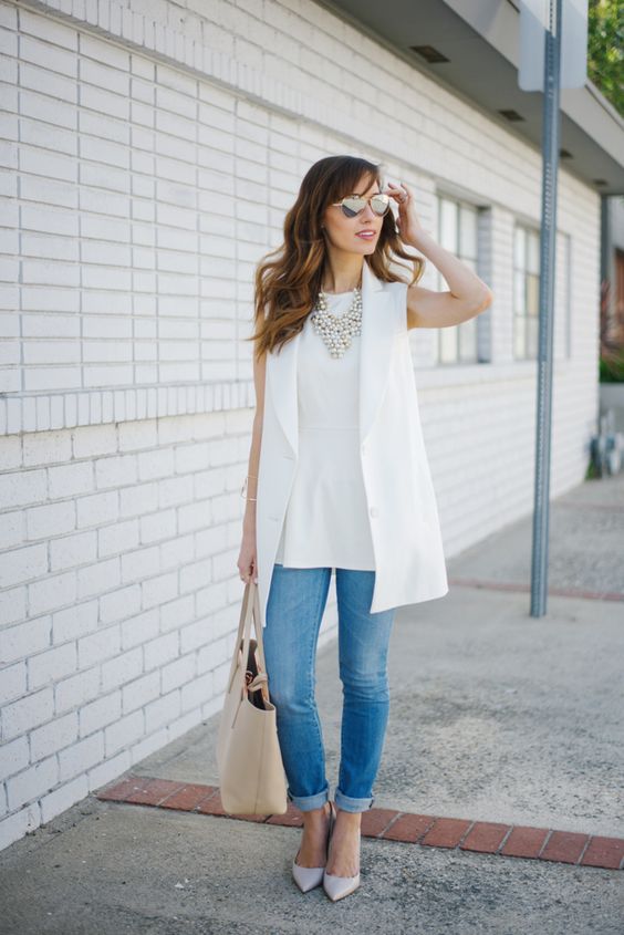 a casual work look with blue skinnies, a white top, a white long vest, layered necklaces and off-white shoes
