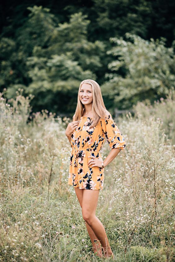 a yellow floral print romper is great for an outdoor shoot in a hot place