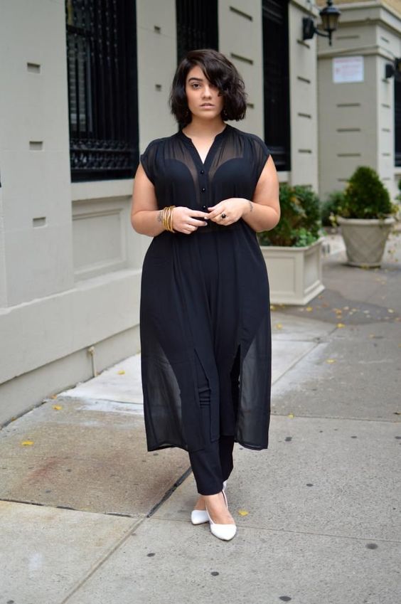 a gorgeous black jumpsuit with a cutout bodice on thick straps and a sheer shirtdress over it for a more modest look