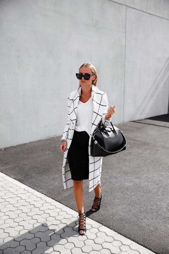 a black pencil skirt, a white tee, black lace up shoes and a black and white windowpane trench