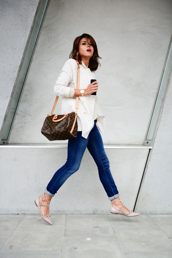 blue skinnies, a white shirt, blush studded flats and a comfy bag can be worn to work