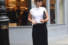 14 a white tee, a black thin-striped midi skirt and flat shoes for a minimal chic look