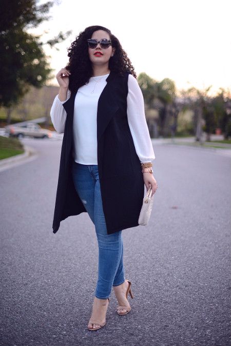 blue skinnies, a white shirt, nude shoes, a clutch and a long black vest for a business casual look