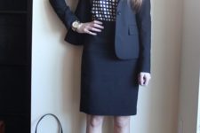 15 a black suit with a knee skirt, a windowpane print top, black shoes and a bag