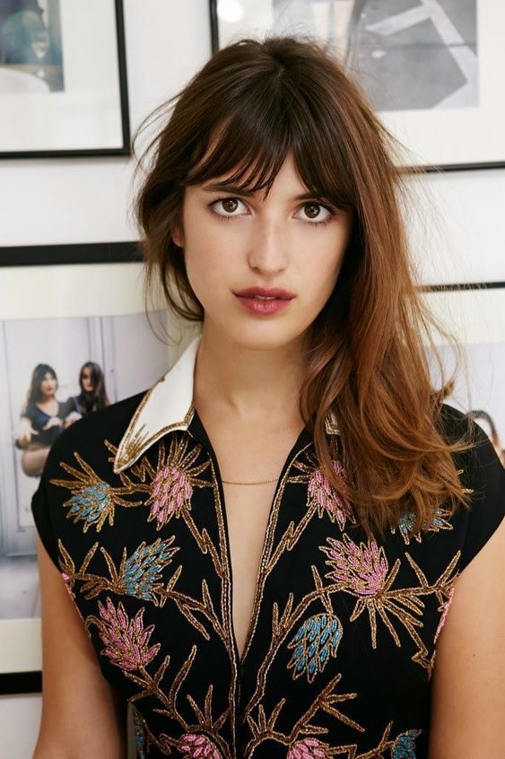 a trendy long bob with some waves and a texture plus a long French fringe