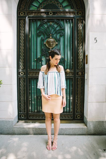 With beige mini skirt and lace up sandals