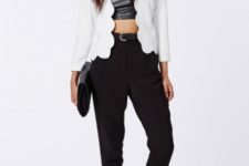 With black leather crop top, black trousers, sandals and black clutch