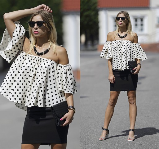 With black mini skirt, black clutch and black and beige sandals