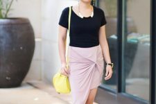 With black t-shirt, pale pink wrap skirt and yellow bag