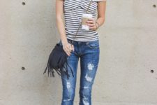 With brown hat, crossbody fringe bag, distressed jeans and black shoes