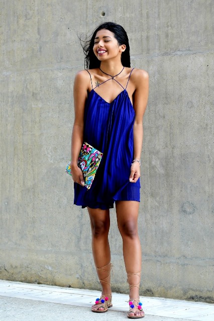 With cobalt blue mini dress and printed clutch