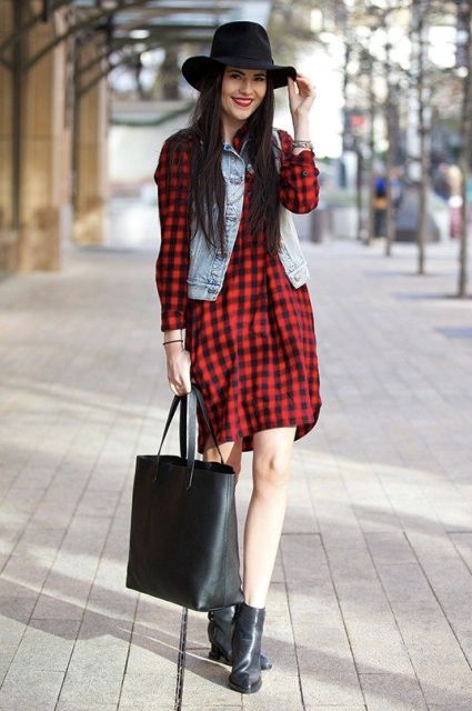 With denim vest, black hat, black leather tote and ankle boots