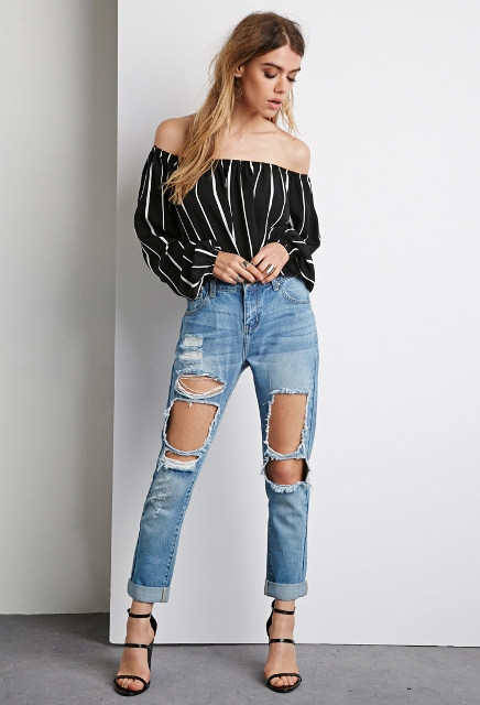 With distressed jeans and black high heels