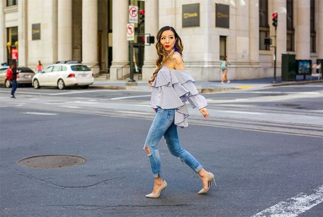 With distressed skinny jeans and beige pumps