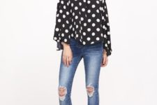 With distressed skinny jeans and black pumps