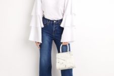 With high-waisted jeans, white bag and black sandals