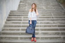 With jeans, black bag and red platform shoes