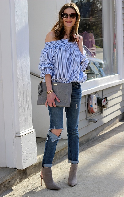 With jeans, gray cutout boots and gray clutch