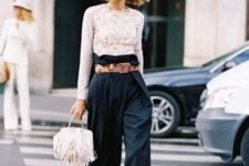 With lace blouse, black heeled sandals and white fringe bag