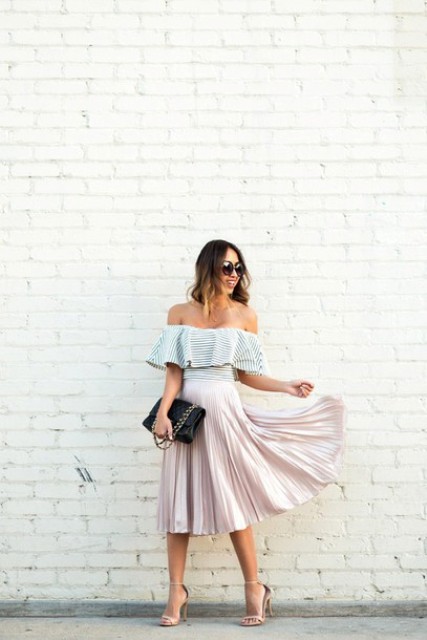 With pleated skirt, high heels and black clutch