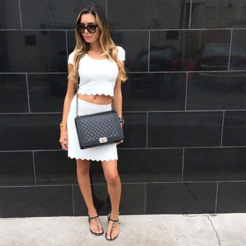 With scallop skirt, black chain strap bag and flat sandals