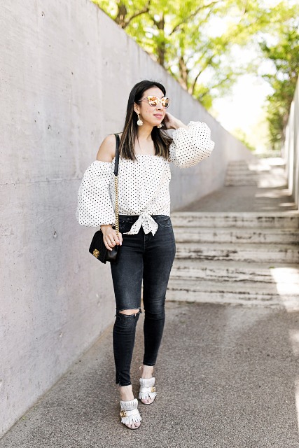 With skinny jeans, black mini bag and white shoes