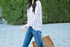 With striped shirt, skinny jeans and brown tote