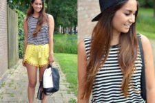 With striped top, black cap, sneakers and black and white backpack