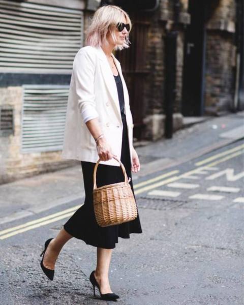 With top, black skirt, white loose blazer and black pumps