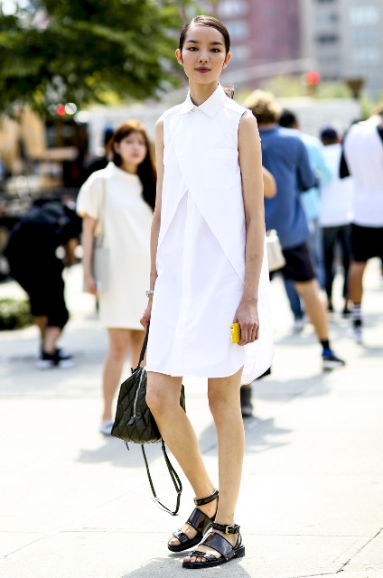 With white dress and black leather bag