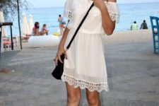 With white lace dress and black bag
