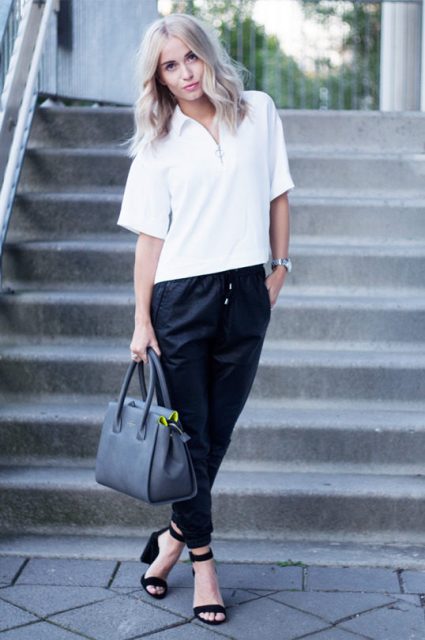With white loose shirt, black sandals and gray bag