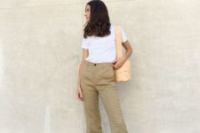 With white shirt, checked flare trousers and beige bag