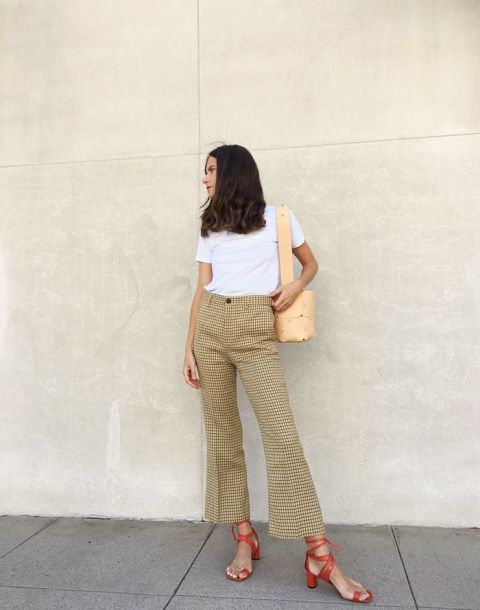 With white shirt, checked flare trousers and beige bag