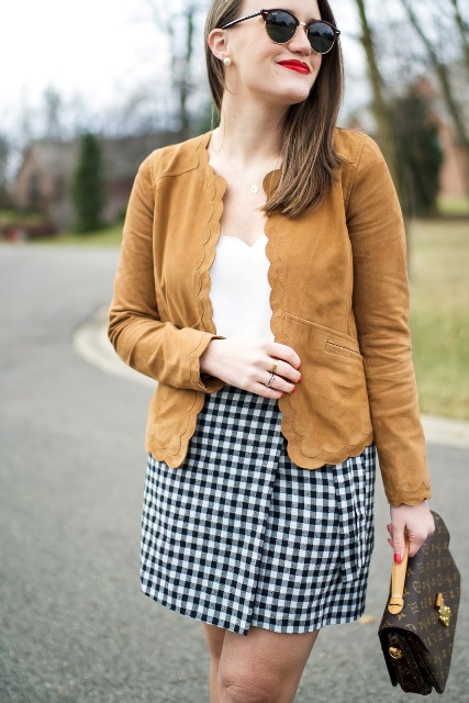 With white top, checked skirt and printed bag
