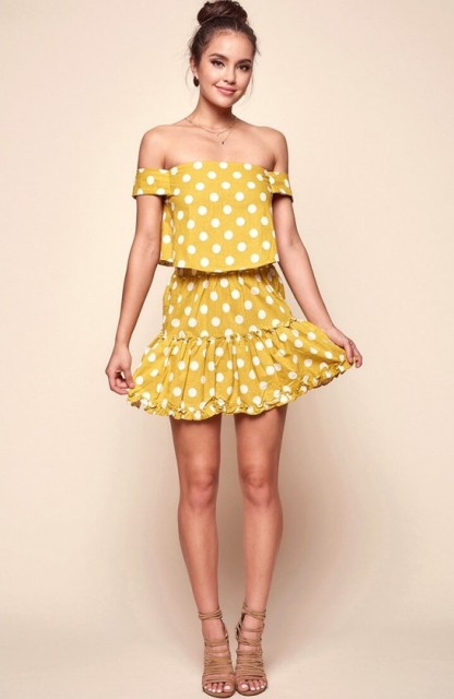 With yellow polka dot skirt and lace up heels