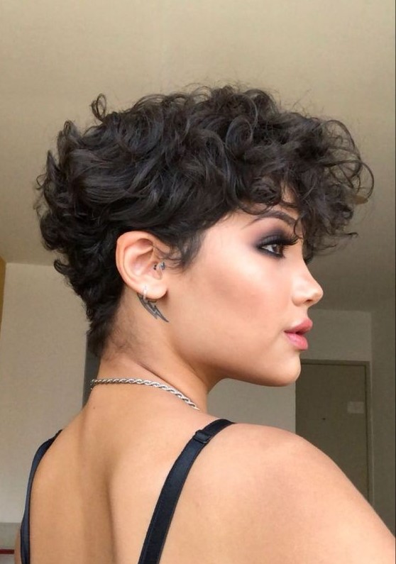 A bold black wavy pixie with a lot of volume and longer bangs is a very beautiful and eye catching idea to try